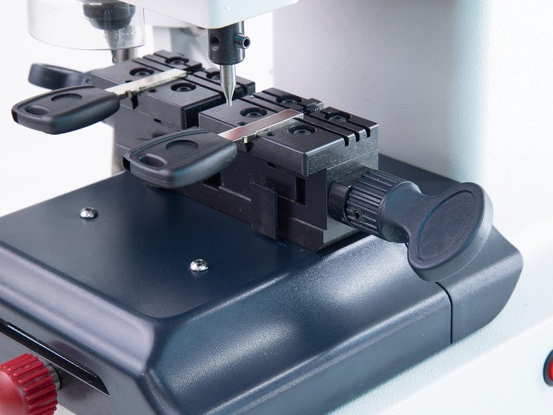 Precision key-cutting machine cutting a car key blank